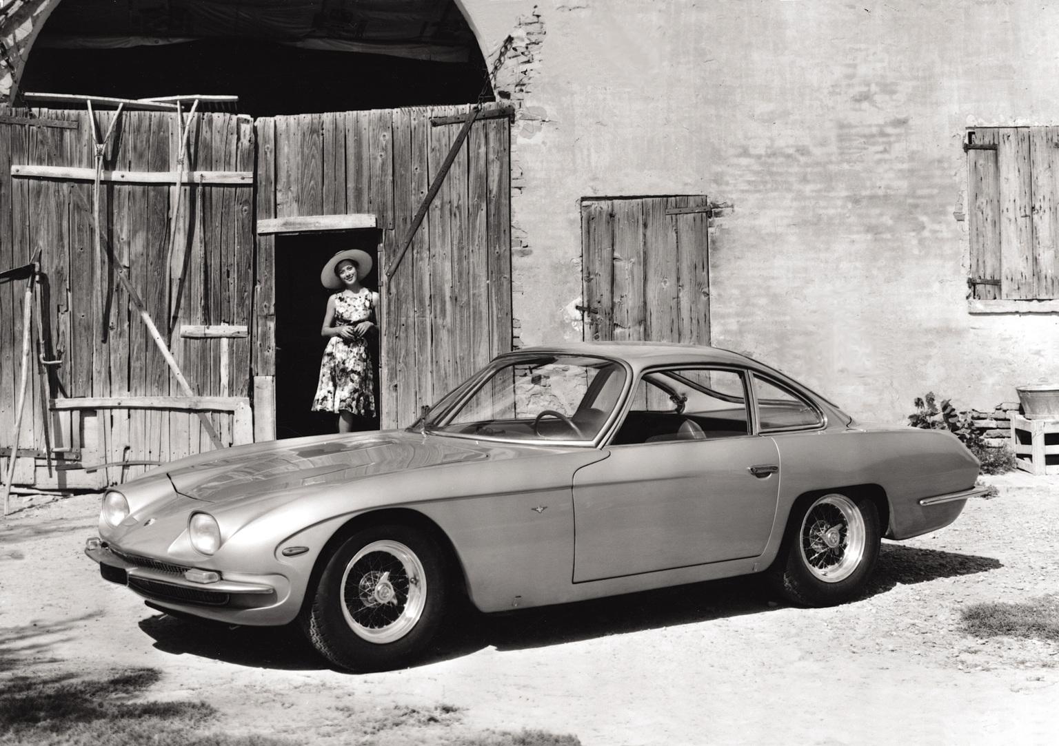 1964 lamborghini 350 gt parked outside of a building